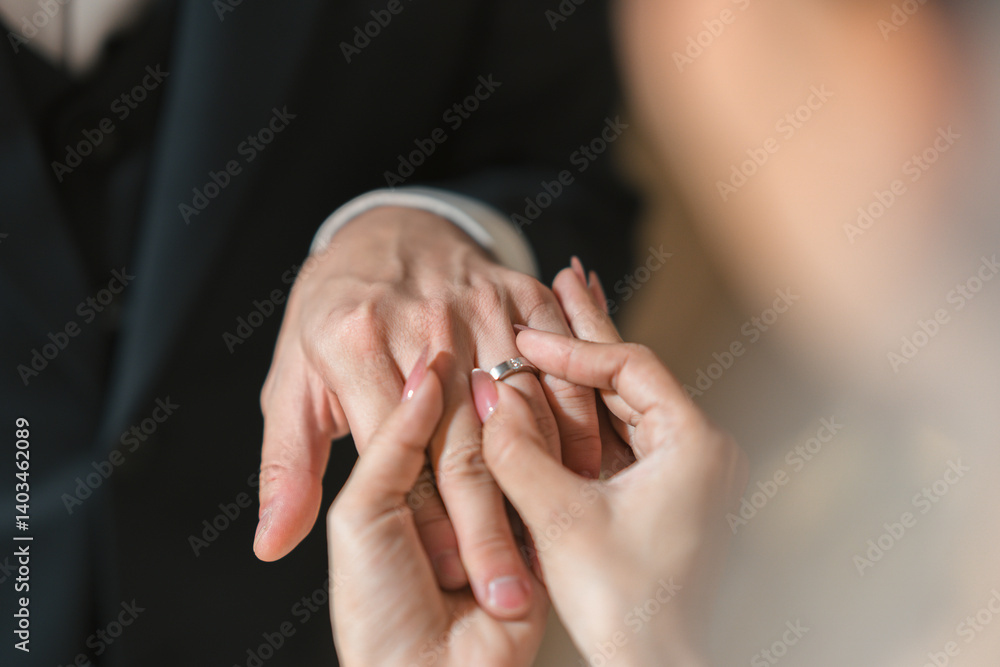 Romantic moment of a bridge and groom exchanging diamond rings during wedding ceremony Romantic moment of a bridge and groom exchanging diamond rings during wedding ceremony