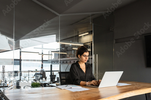 Wallpaper Mural Young middle eastern or indian businesswoman in formal clothes and eyeglasses sitting at desk workplace working on computer. Latin business entrepreneur woman it specialist typing, browsing in office Torontodigital.ca