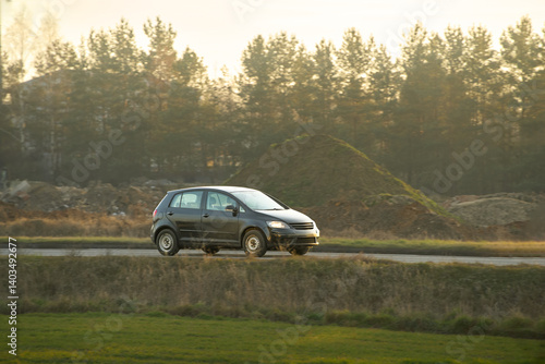 Obraz na płótnie Compact hatchback driving on country road w salonie
