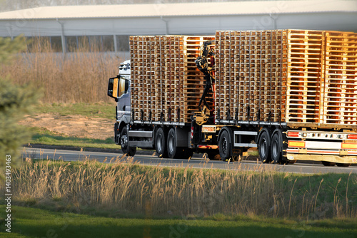 Obraz na płótnie Logistics truck with stacked wooden pallets w salonie