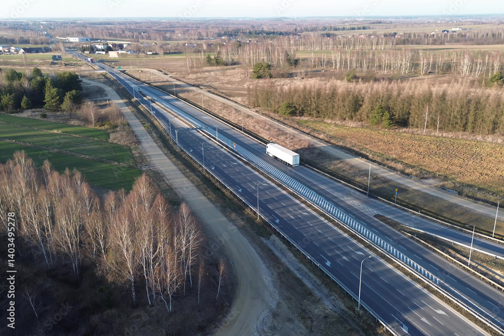 White logistics truck speeding on open highway