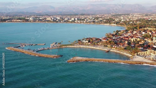 Side, Türkiye, aerial view of the waterfront, yacht marina and Temple of Apollo at sunset.