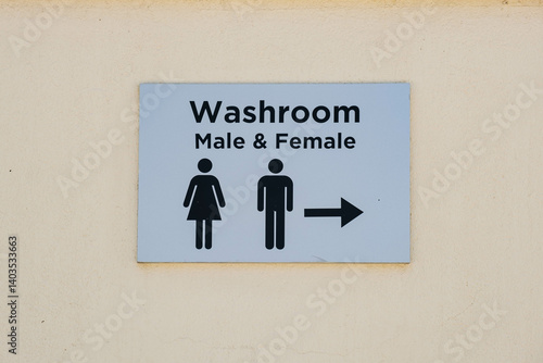 Obraz na plátně A clear and straightforward washroom sign indicating male and female facilities with a directional arrow