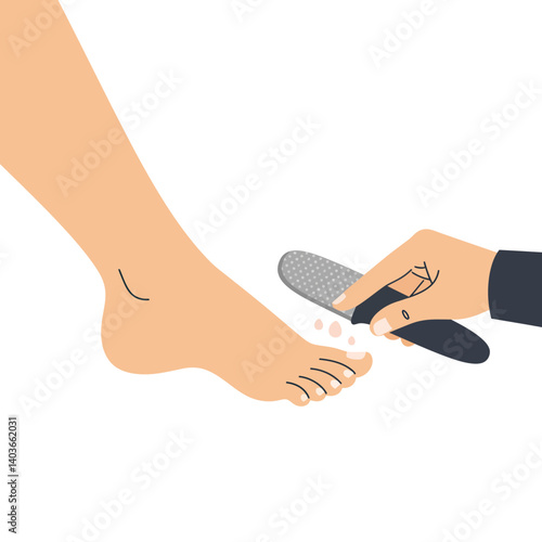 Hand holding foot file to smoothen a foot during a pedicure session