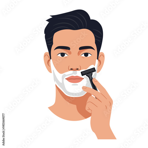 Young man shaving his face with a razor while applying shaving cream in a bathroom