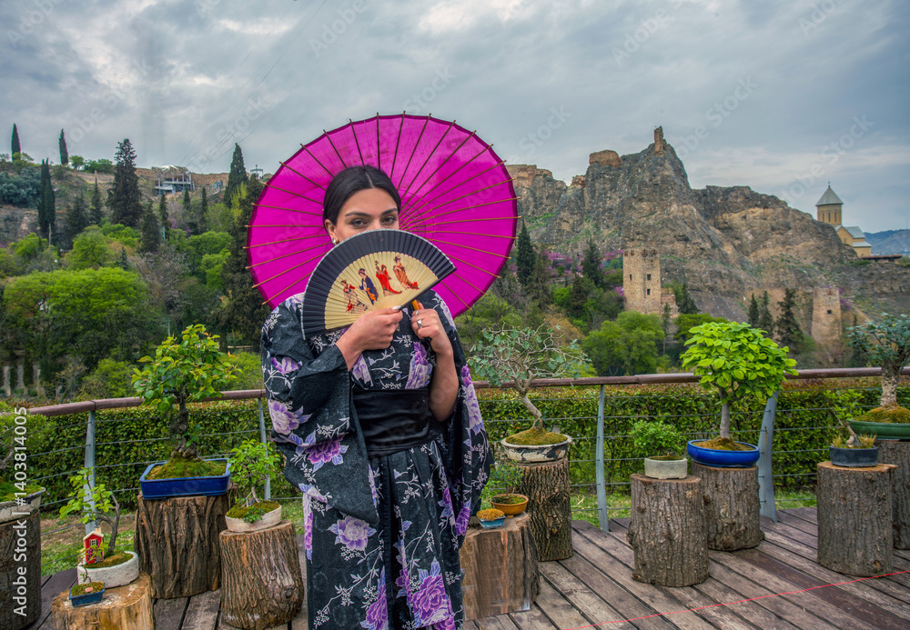 Beautiful young woman in Japanese kimono and close face with on holiday of cherry blossom
