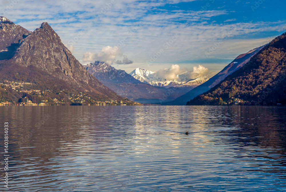 Lugano lake - view on water and European alps or Swiss Alps