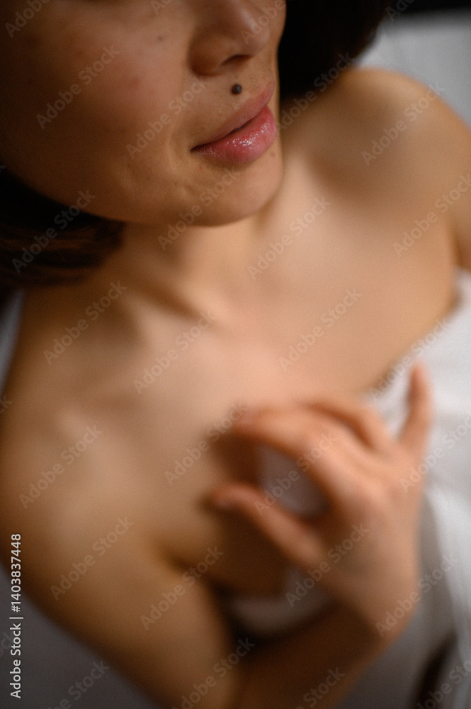 A woman’s hand gently glides over her shoulder and collarbone. A graceful moment capturing elegance, self-care, and beauty, showcasing the softness and delicacy of the body. A woman’s hand gently glides over her shoulder and collarbone. A graceful moment capturing elegance, self-care, and beauty, showcasing the softness and delicacy of the body.