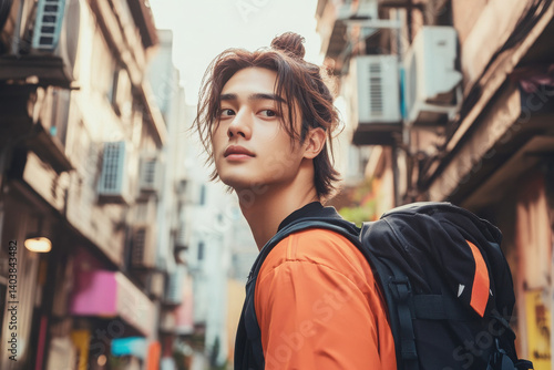A young traveler explores an urban landscape, showcasing a blend of adventure and modern culture with a stylish backpack.