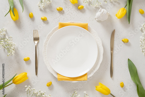 Obraz na płótnie Easter table setting with spring, yellow tulips, empty white plates, bunny, eggs on white background. Happy Easter celebration. Copy space. View from above. w salonie