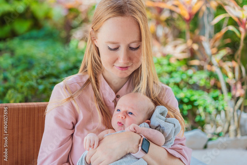 Obraz na płótnie A mother lovingly embraces her newborn baby, holding them close to her chest. A tender moment of warmth, security, and deep maternal love, symbolizing bonding, comfort, and the unbreakable connection w salonie