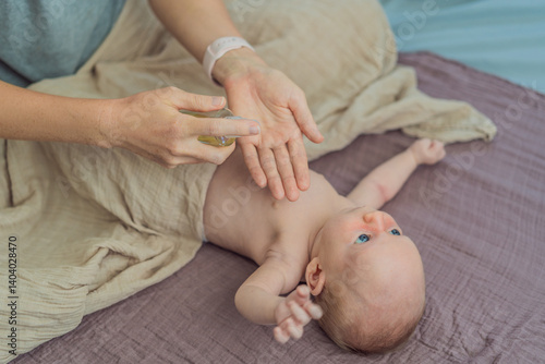Obraz na płótnie A mother gently massages her 1-month-old baby with baby oil after a bath. This tender moment highlights the bond between parent and child, promoting relaxation, baby care, and the importance of skin w salonie