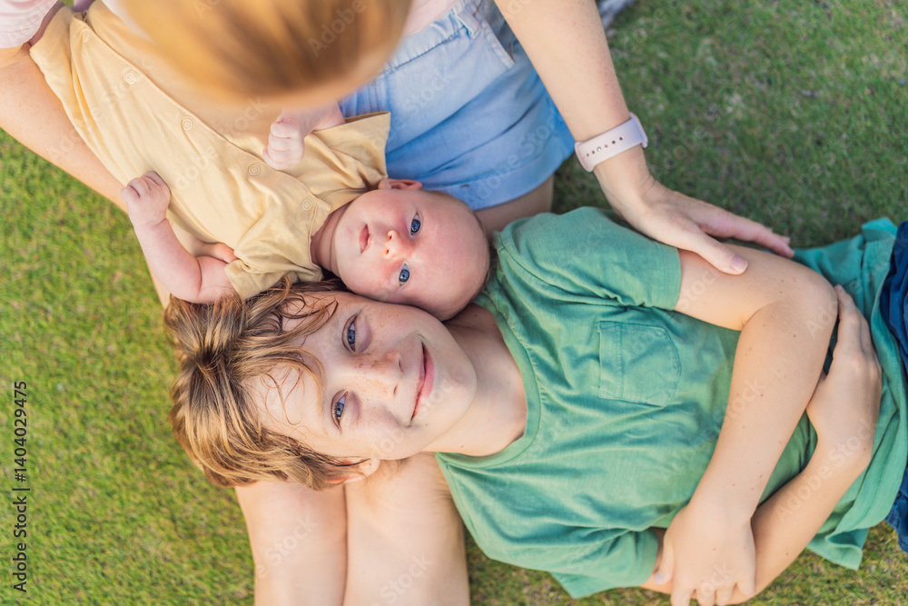 Young mother, teenage son, and one-month-old baby enjoying quality family time in the park. Multigenerational bonding and outdoor family love concept
