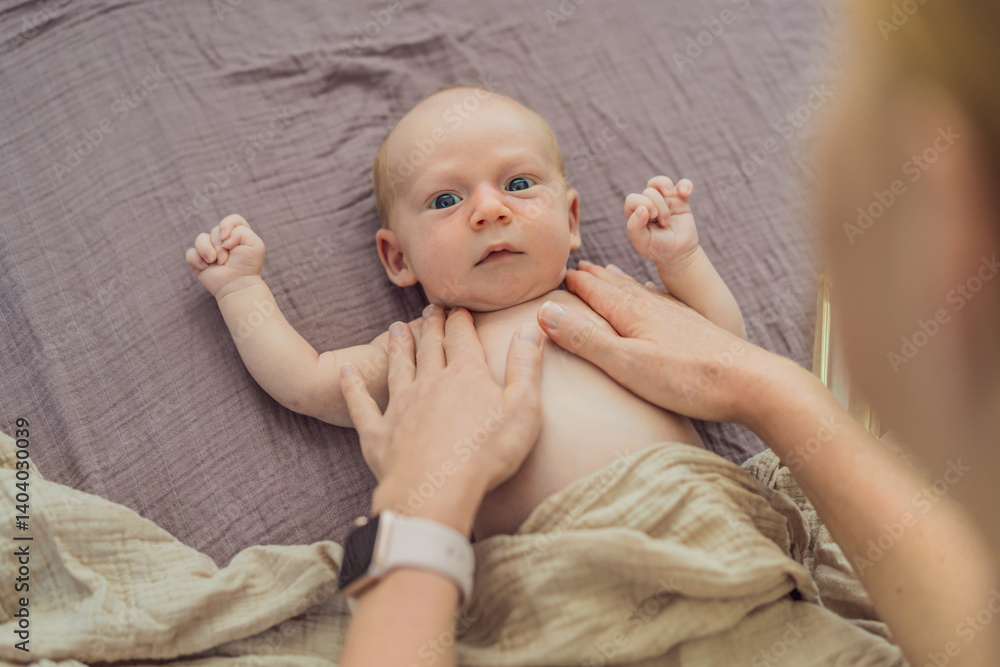 A mother gently massages her 1-month-old baby with baby oil after a bath. This tender moment highlights the bond between parent and child, promoting relaxation, baby care, and the importance of skin