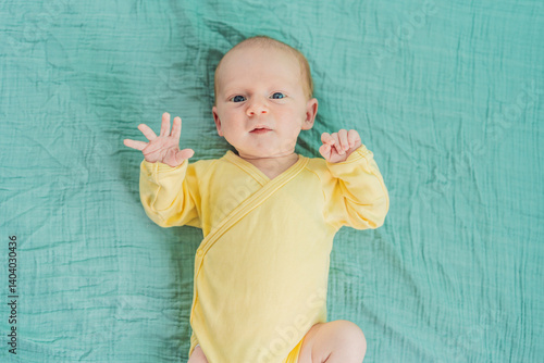 Obraz na płótnie A newborn baby rests peacefully on a soft muslin swaddle, feeling comforted and secure. A tender moment of early childhood, warmth, and tranquility, symbolizing gentle care and a nurturing environment w salonie