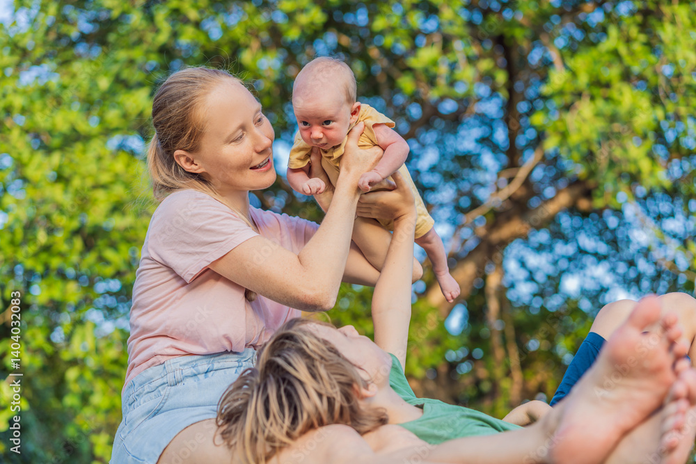 Young mother, teenage son, and one-month-old baby enjoying quality family time in the park. Multigenerational bonding and outdoor family love concept