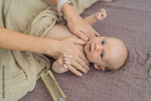 Obraz na płótnie A mother gently massages her 1-month-old baby with baby oil after a bath. This tender moment highlights the bond between parent and child, promoting relaxation, baby care, and the importance of skin w salonie
