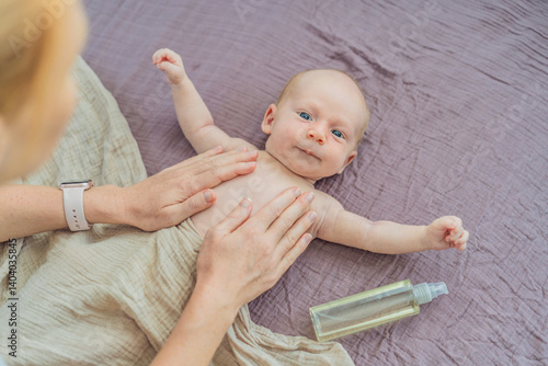 A mother gently massages her 1-month-old baby with baby oil after a bath. This tender moment highlights the bond between parent and child, promoting relaxation, baby care, and the importance of skin