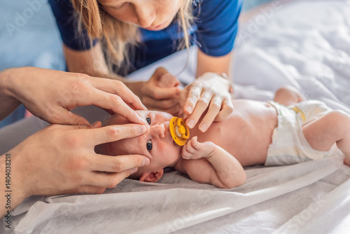 A newborn baby receives gentle osteopathic care, lying calmly while the specialist carefully examines and adjusts the infant. A moment of professional pediatric care, early development, and holistic