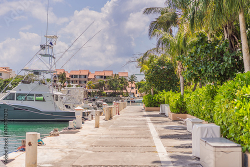 A scenic marina filled with luxurious yachts docked in calm waters, reflecting the beauty of a coastal lifestyle. A serene and elegant setting representing travel, wealth, relaxation, and nautical