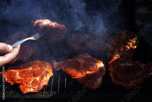 Obraz na płótnie Juicy steaks sizzling on an outdoor grill