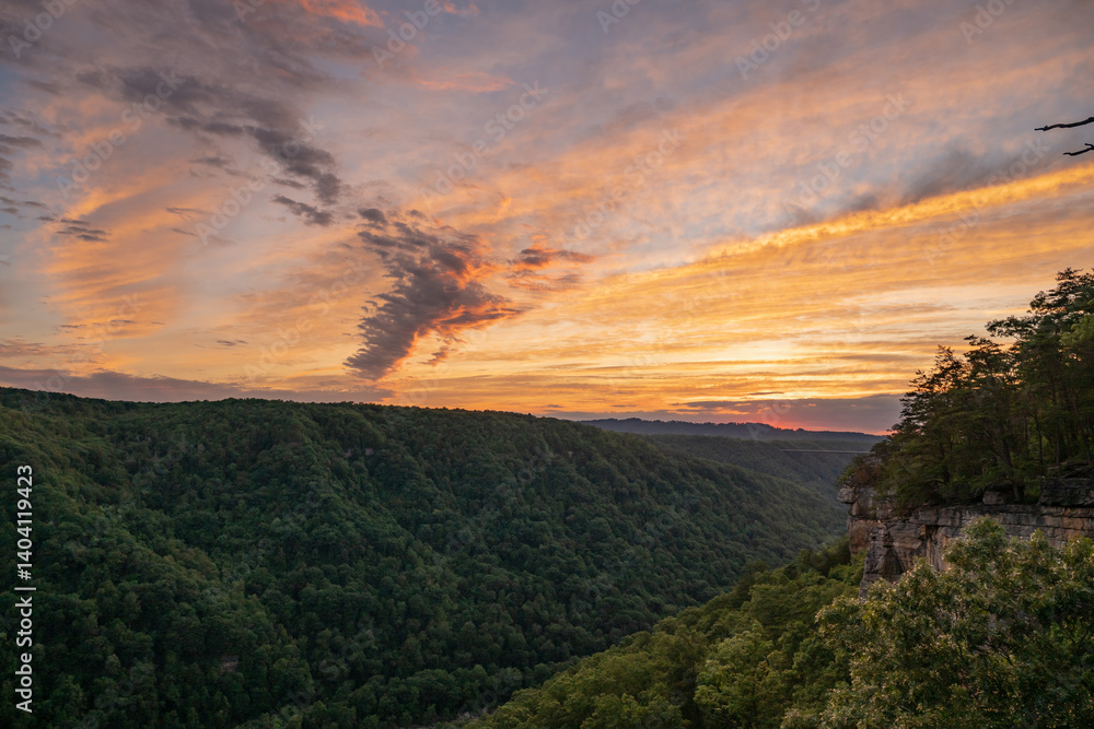 Layers of Clouds Catch Evening Sunlight Color Over New River Gorge