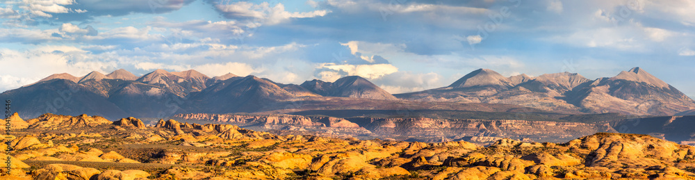 Petrified Dunes and La Sal mountain range panorama in Arches National Park, Utah. The formations were produced when ancient sand dunes hardened into stone.