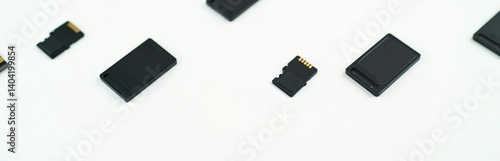Black memory cards on white background. SD, micro SD storage devices. Compact flash cards. Information storage technology, data transfer, backup, digital data, portable storage devices.