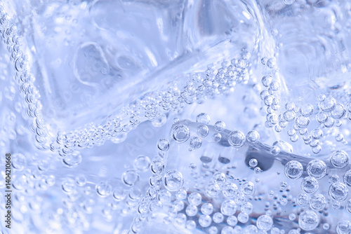 Soda water with ice as background, closeup