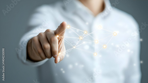 Man in White Shirt Pointing at Digital Network of Glowing Nodes on Gray Background