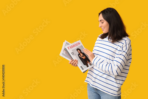 Young woman with magazines ...