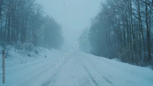 Frozen country road covered in snow during heavy blizzard and snowstorm