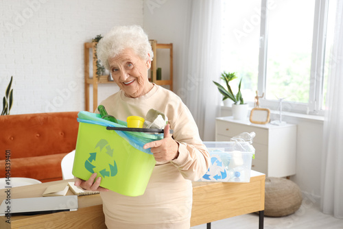 Senior woman with garbage b...