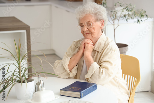 Senior woman with Bible pra...