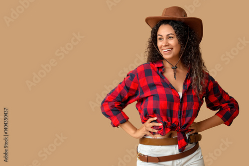 Smiling young woman in cowb...