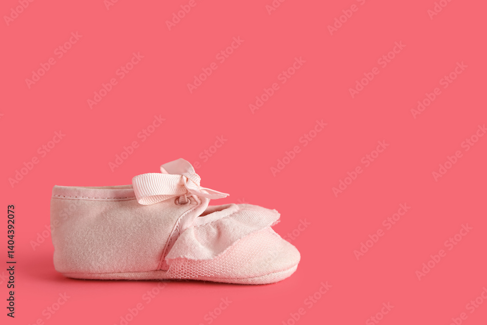Cute baby bootie on pink background Cute baby bootie on pink background