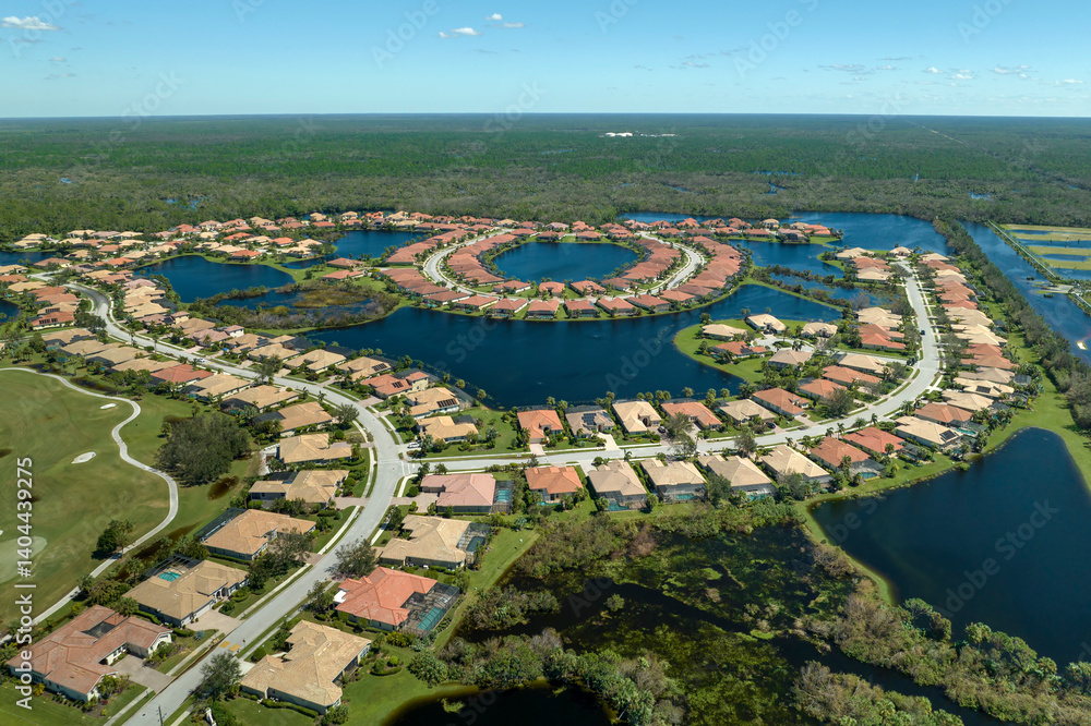 Fototapeta premium Consequences of natural disaster. Heavy flood with high water surrounding residential houses after hurricane Ian rainfall in Florida residential area