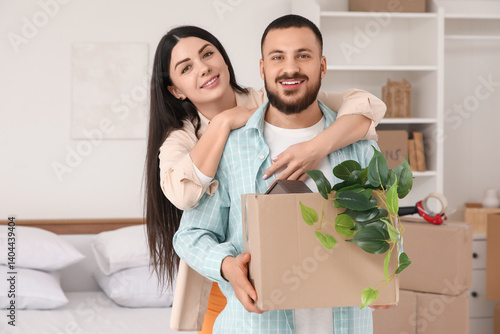 Happy young couple moving i...