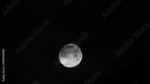 dark clouds move quickly past the full moon