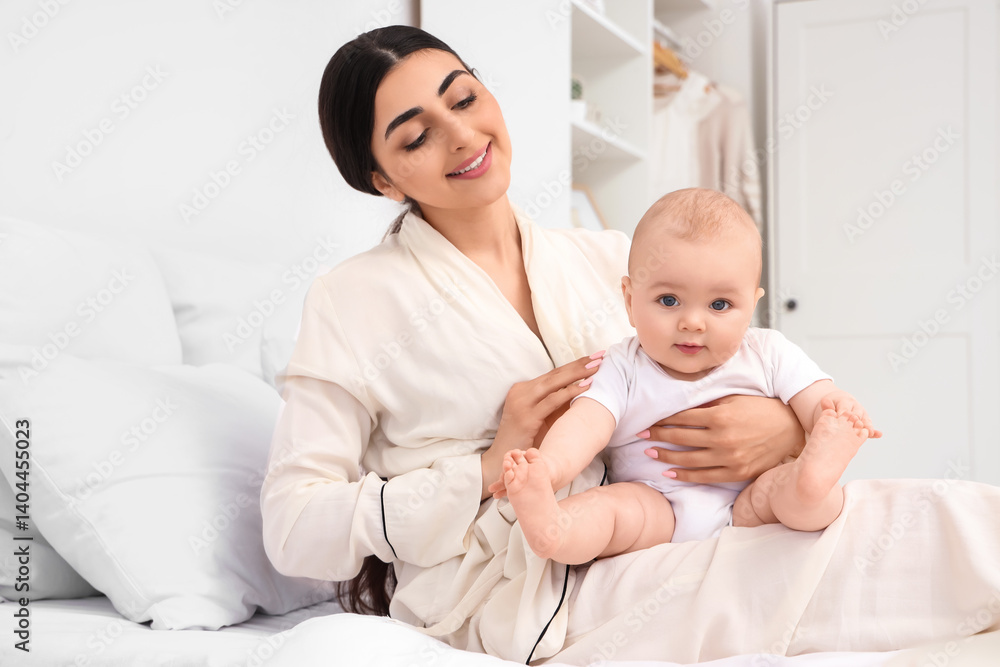 Happy mother with her little baby sitting in bedroom Happy mother with her little baby sitting in bedroom
