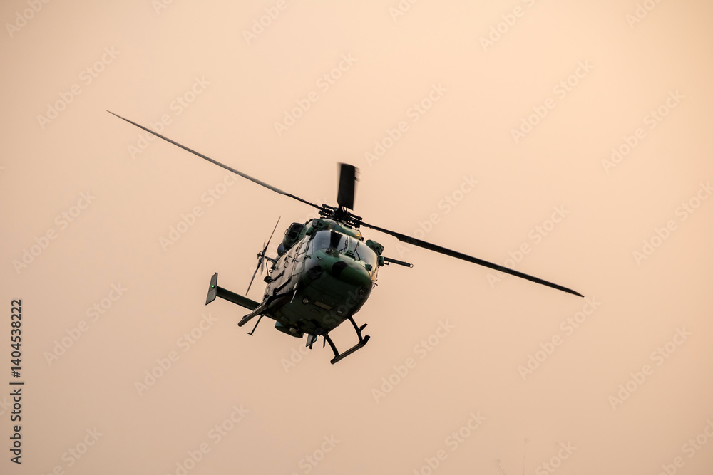 Helicopter is turning in sky during sunset Helicopter is turning in sky during sunset