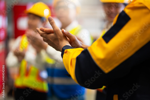 Clapping. Unity and teamwork concept. Professional diverse team standing hands together. Professional Mechanical Engineer team Working at metal sheet profiling factory. Industrial production