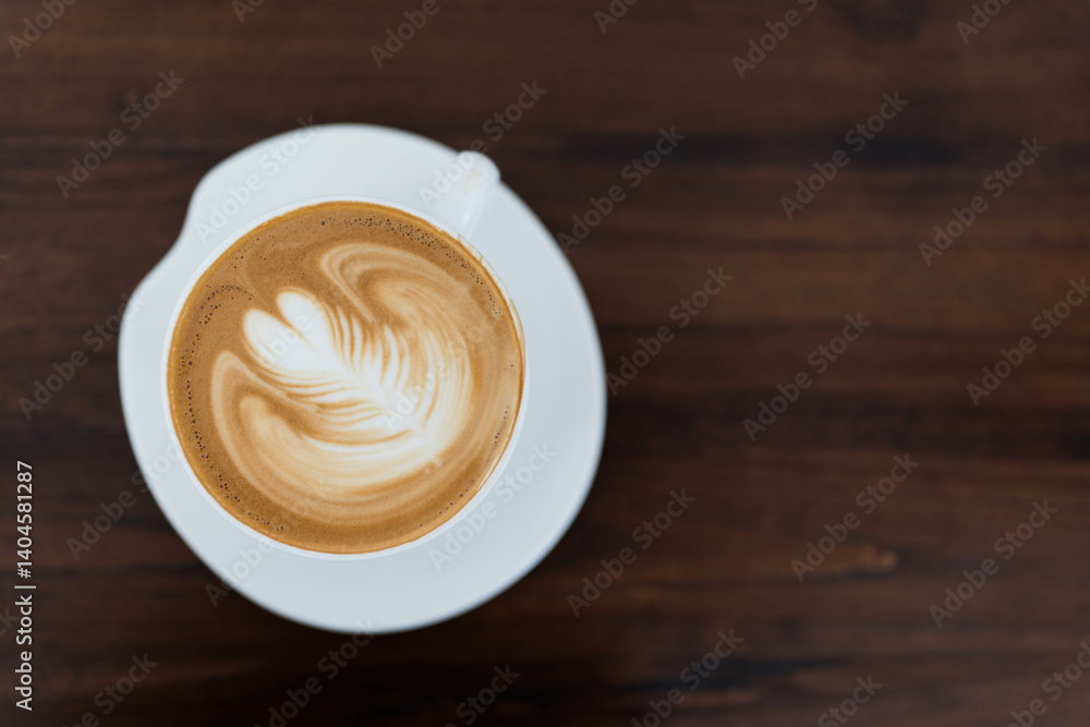 A steaming hot coffee with latte art in a cozy cafe setting. A steaming hot coffee with latte art in a cozy cafe setting.