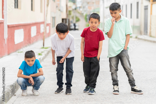 Hispanic children playing marbles in the street in South America