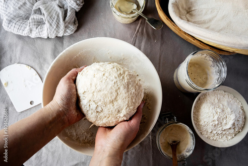 Female hands holding sourdough dough in hands