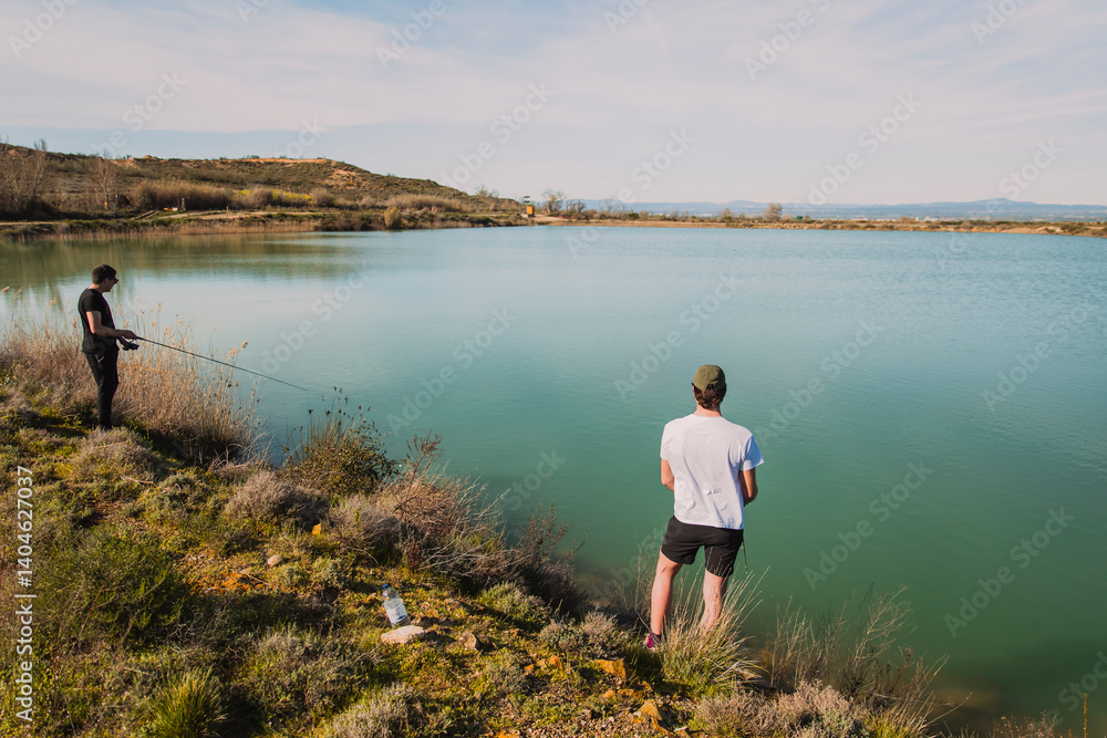 Naklejka premium Two Men Fishing on a Sunny Day by the Lake
