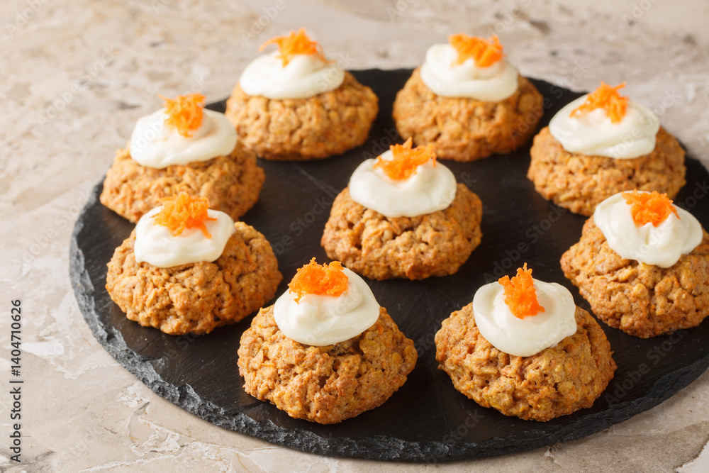 Homemade Carrot oatmeal cookie cake with cream cheese frosting close-up on plate on table. Horizontal