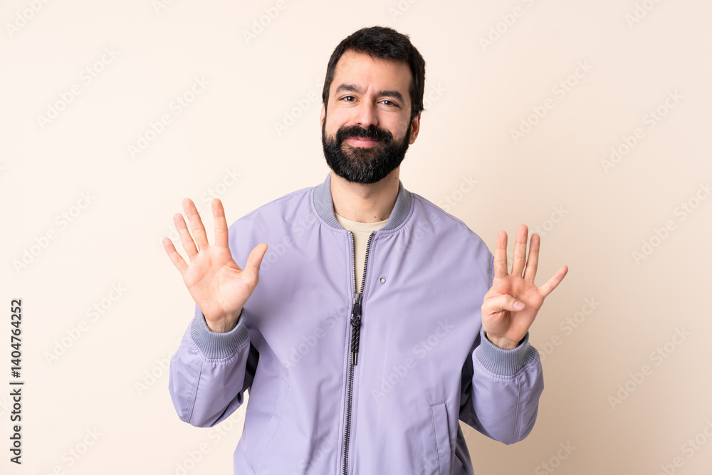 Naklejka premium Caucasian man with beard wearing a jacket over isolated background counting nine with fingers