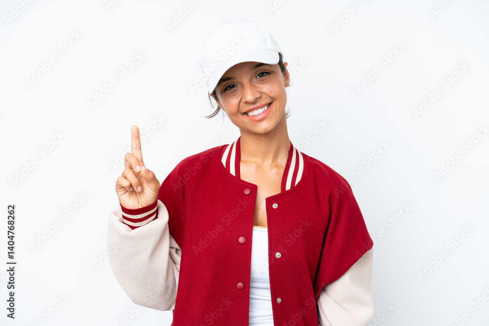 Young hispanic woman wearing a baseball uniform isolated on white background showing and lifting a finger in sign of the best Young hispanic woman wearing a baseball uniform isolated on white background showing and lifting a finger in sign of the best