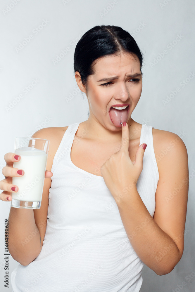 Expression of a brunette girl holding a glass of milk, kefir, Expression of a brunette girl holding a glass of milk, kefir,